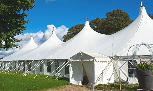 a line of portable restrooms in a shaded area, offering a comfortable experience for users in Waddell